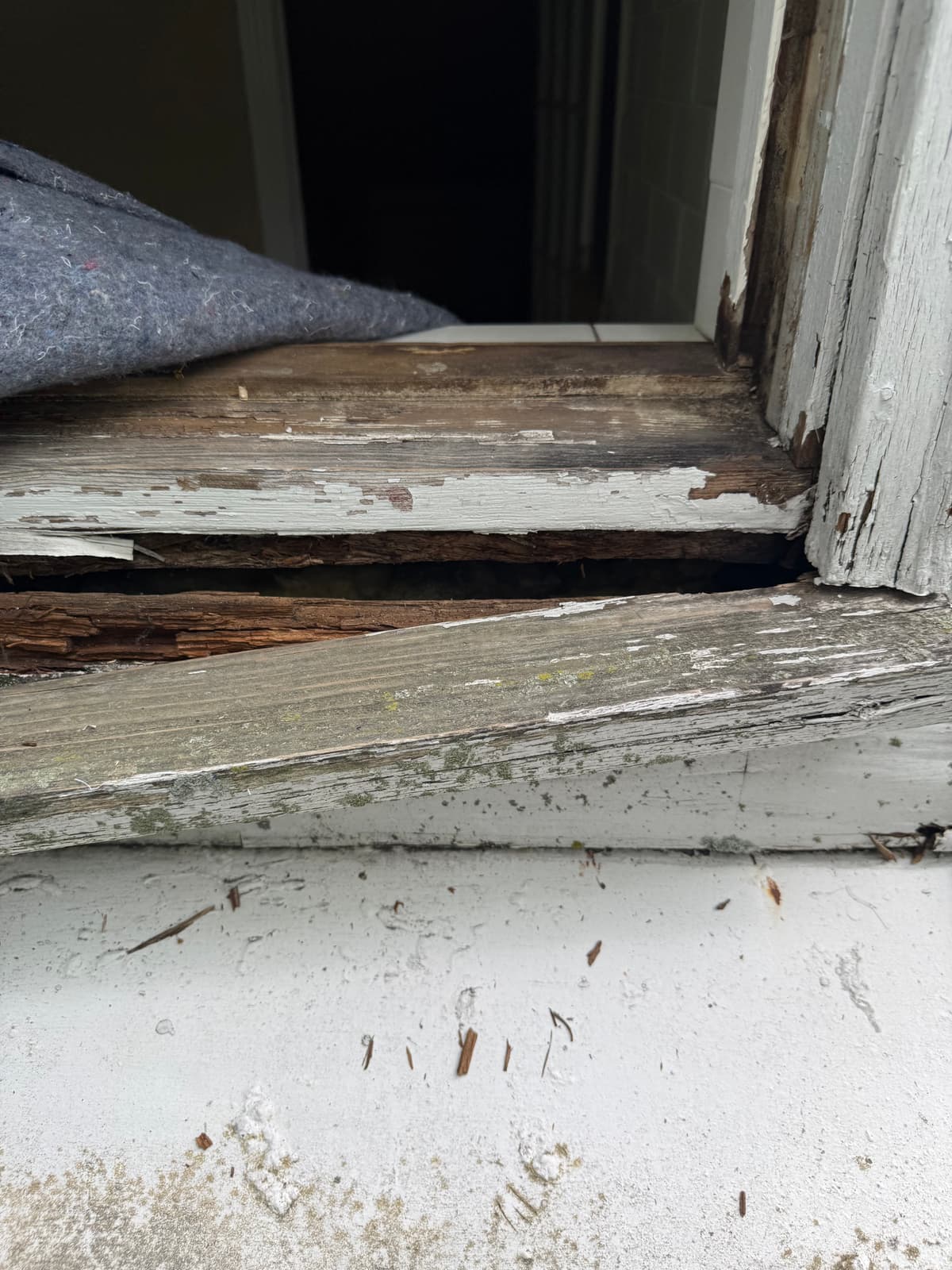 Bottom right corner of the opening, rotted through.