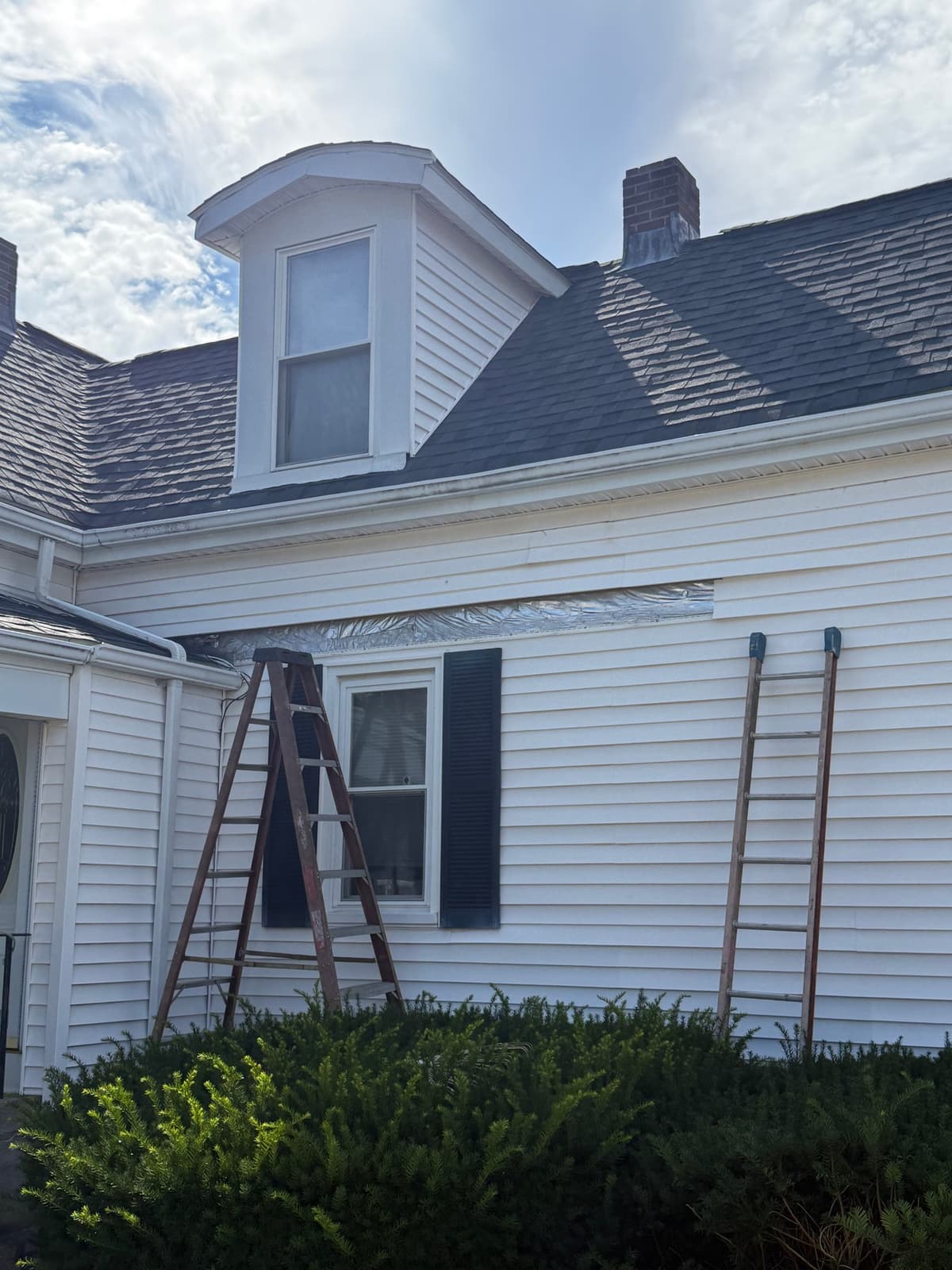 Access set up and the damaged panel out, house wrap and insulation board exposed underneath.