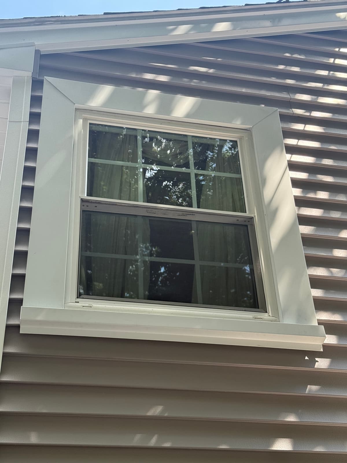 Custom J-less trim going up around a dormer window: no J-channel, no plastic edge showing.